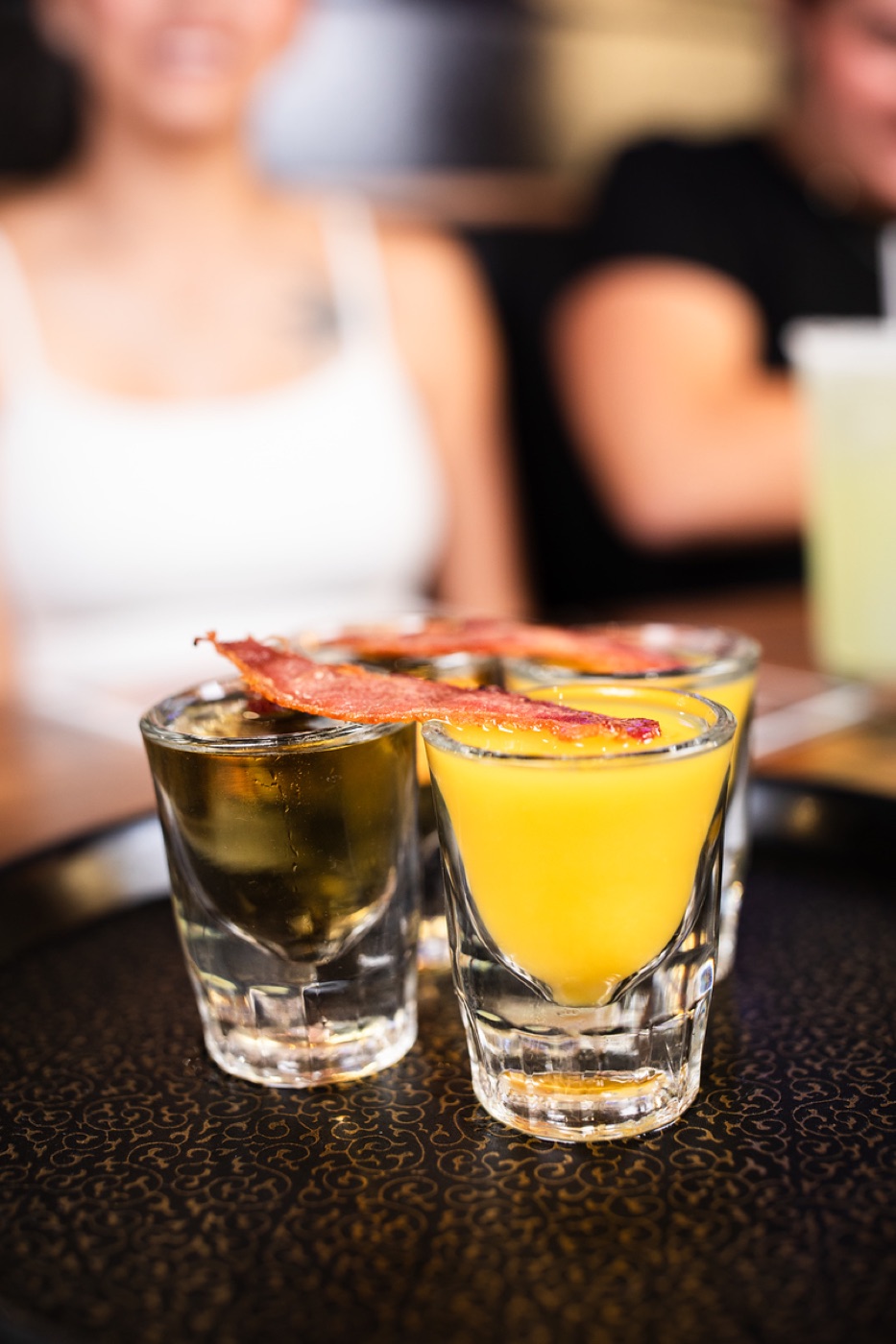Shots garnished with strips of bacon