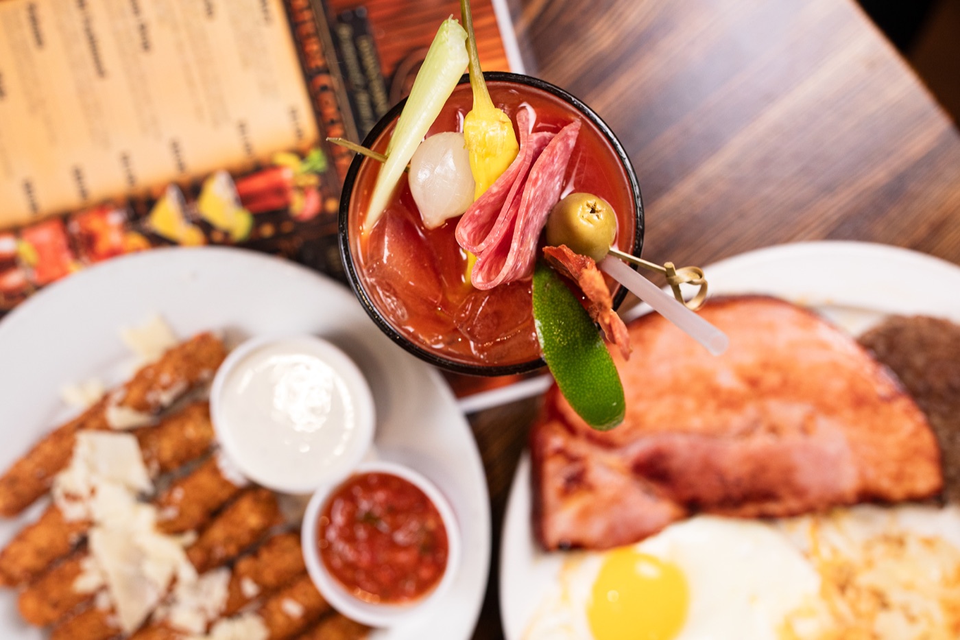 Bloody Mary with breakfast plates seen from above