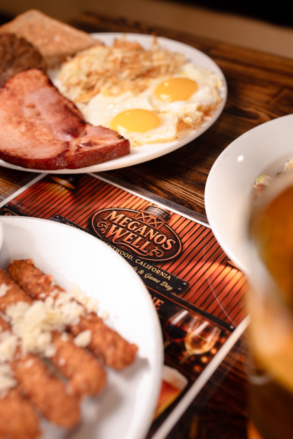 Ham, eggs and hash browns next to the menu
