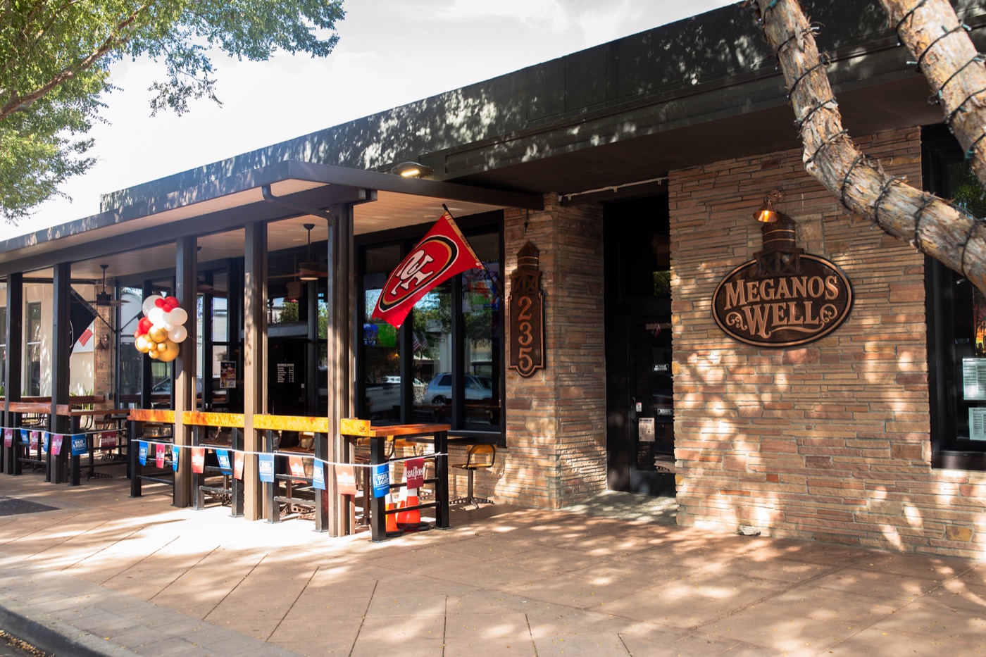 The front door and patio tables at Meganos Well