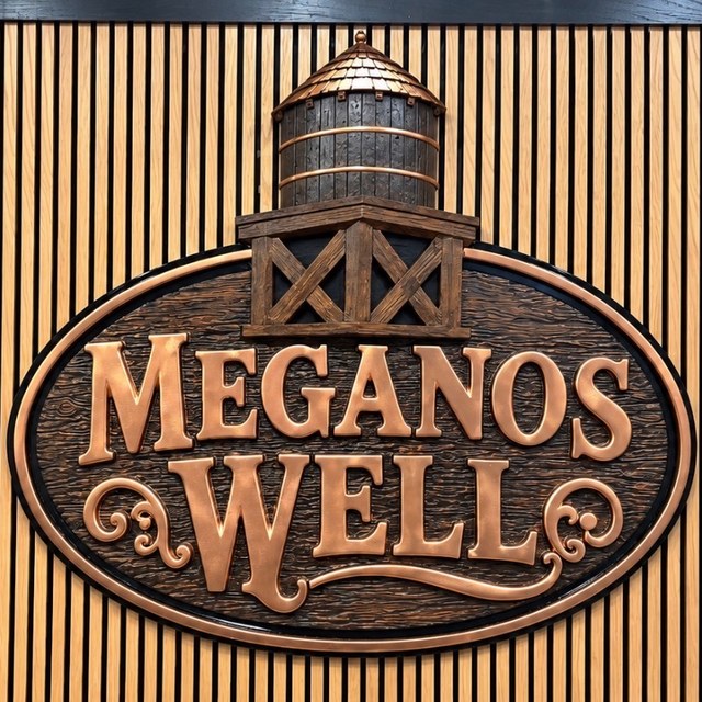 Meganos Well carved sign