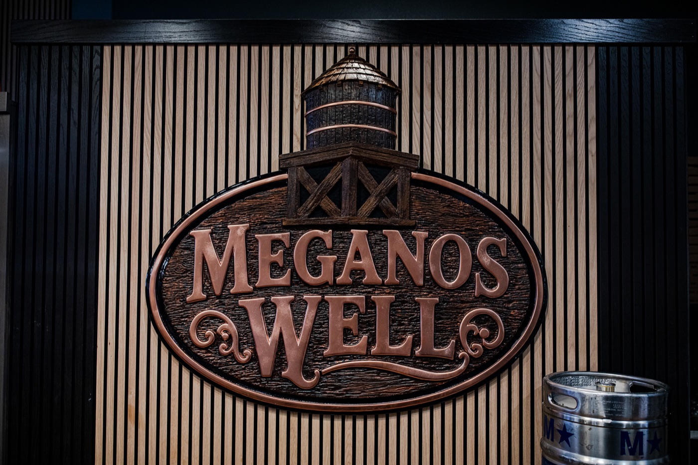 The carved wooden Meganos Well sign